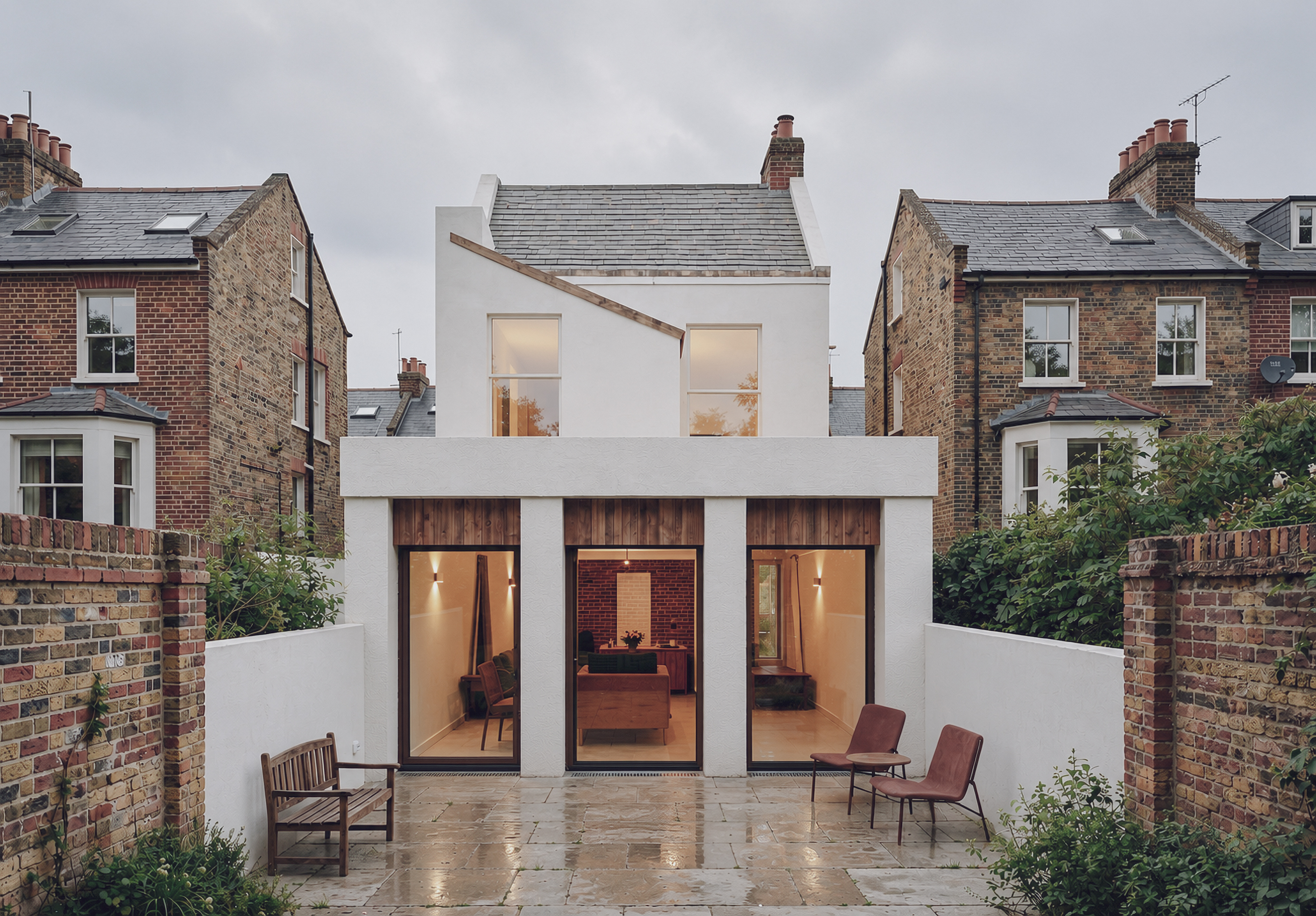 Ashfield House rear extension with white rendered volume and timber-lined openings
